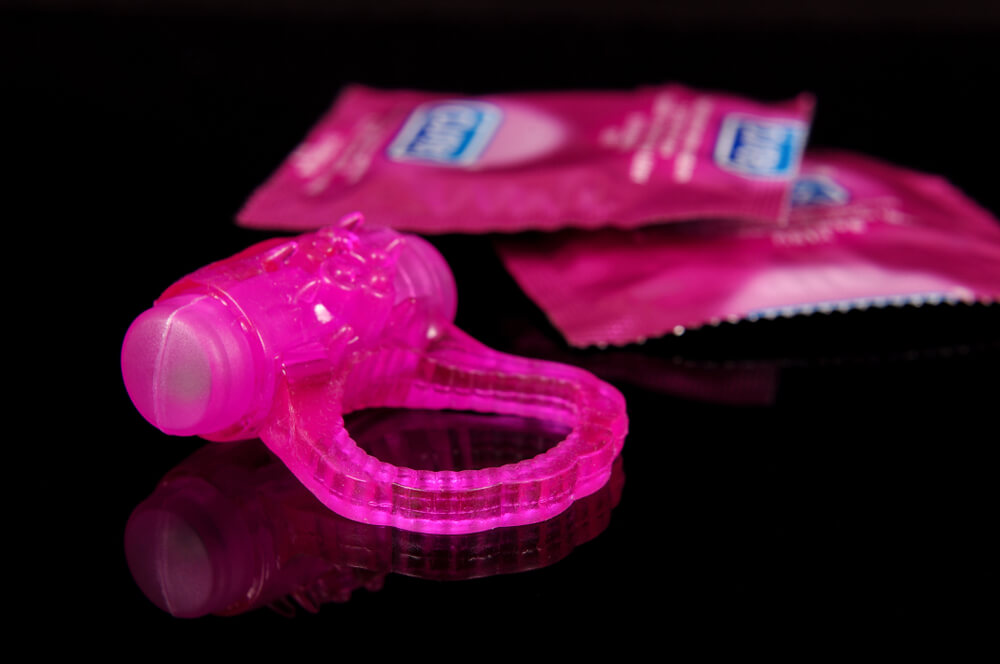 Vibrating Penis Ring and Condoms Isolated On the Black Background